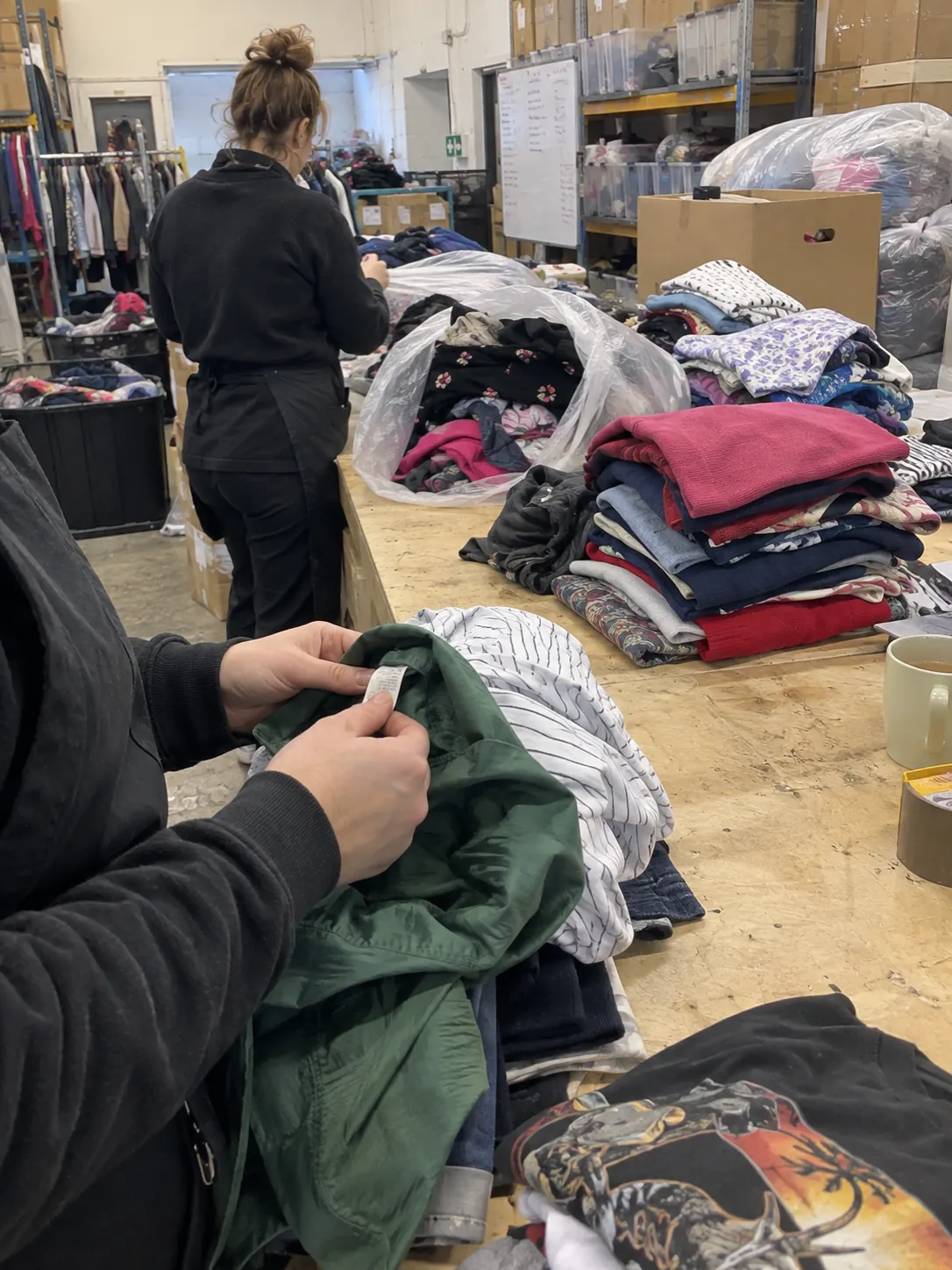 Sorting and grading clothing by hand at the table